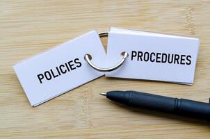 Policies and Procedures text on notepad representing operational guidelines and internal controls photo