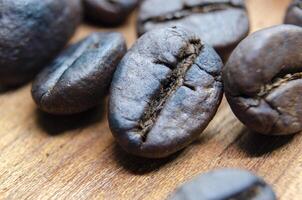 Close up view roasted coffee beans that highlights the texture and surface details of the coffee beans with customizable space for text. photo