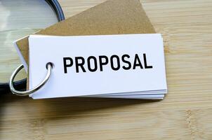 Proposal text on notepad denoting submission of ideas, business bids, or plans photo