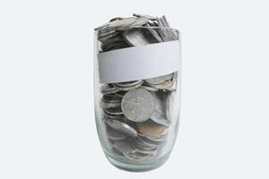 Coins rupiah in glass with white label tape on white background. Money savings concept photo