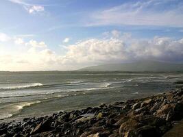 a view of the ocean from a rocky shore photo