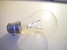 a light bulb on a table with wires photo
