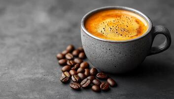 Rich espresso served with coffee beans. A dark espresso cup sits on a gray surface with scattered coffee beans, showcasing their rich color and texture. photo