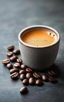 Freshly brewed coffee in a rustic cup. A rustic ceramic cup filled with steaming coffee, accompanied by scattered coffee beans on a dark surface. photo