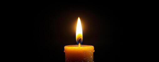 Candle flame glowing in dark environment. A single candle burns brightly in a dark space, casting warm light and creating a tranquil atmosphere. photo