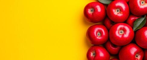 Red apples on yellow. Bright red apples arranged neatly against a bold yellow backdrop create a cheerful and inviting display. photo