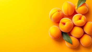 Peaches on yellow backdrop. Ripe peaches with soft skin and vibrant color arranged on a bright yellow surface, highlighting their freshness. photo
