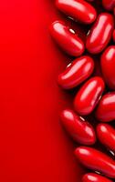 Red kidney beans on vibrant background. Red kidney beans arranged on a bright red background create a striking visual display of color and shape. photo