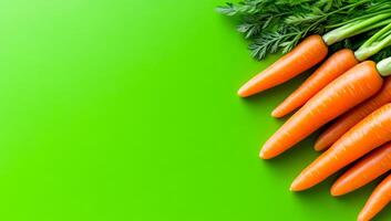 Fresh carrots on green. Bright and vibrant carrots with green tops are arranged on a vivid green surface, showcasing their freshness and color. photo
