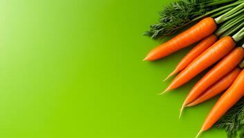 Carrots on green background. Vibrant orange carrots with green tops are neatly displayed on a lively green surface, highlighting their freshness. photo