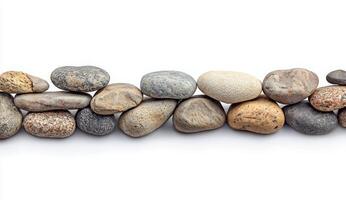 Smooth River Stones Lined Up on White Background for Decorative Use photo