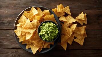 Nachos with guacamole on a wooden table top view photo