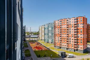Colorful residential buildings and a landscaped area with a playground, top view photo