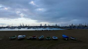 A row of boats on the sand photo