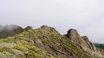 A mountain with a cable car on top photo