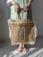 A woman holding a bag with a design on it photo