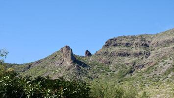 A mountain with a clock tower on top photo