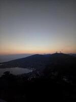 A view of a city at dusk from a hill photo