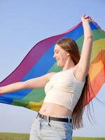 A woman is holding a rainbow flag photo