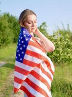 A woman is holding an american flag photo