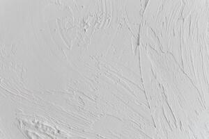 Textured white wall with subtle patterns from recent plastering work photo