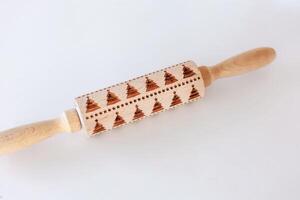 Unique wooden rolling pin with intricate patterns for baking projects and culinary creativity photo