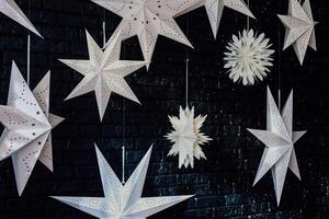Hanging paper stars create a magical atmosphere in a cozy indoor space during the winter season photo