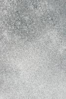 Gray textured surface with subtle variations in tone and pattern observed in natural light photo