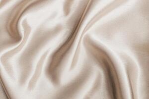 Soft satin fabric draped elegantly with gentle folds and a smooth surface photo
