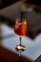 Cocktail with lime and ice in a glass on a dark background photo