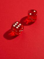 Red and white dices on a red photo