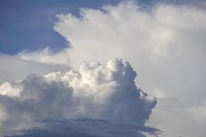 White clouds form in the blue sky before the rain begins to fall. photo