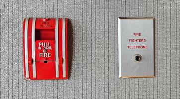 Fire alarm switch box and firefighter telephone port for connect or calling on gray background Device or tool for pull out in case of fire and prevent emergency event and Protect concept. photo
