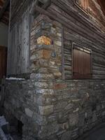 Close up of traditional stone and wood structure in aosta, italy, showcasing rustic architectural details and textures in a november setting Lillaz photo