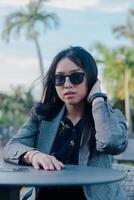 Stylish woman portrait in the tropical setting with gray blazer photo