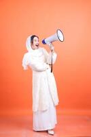 Energetic Announcement, Cheerful woman using a megaphone to comm photo