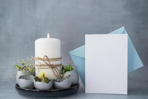 Easter mock up envelope empty card template Creative handmade Easter table decoration with egg shells instruction candle. Easter home decoration. Seasonal sustainable recycled decor photo