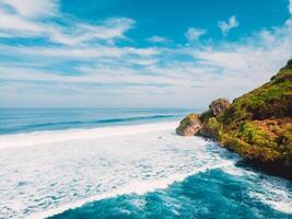 Amazing view of scenic coastline with waves in ocean in Bali. Nyang Nyang beach. photo