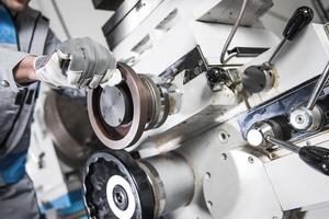 Worker Operating Machinery in a Factory Setting Showing Precision Engineering Techniques photo