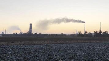 Heavy gray smoke is poured from the chimney pipes of thermal power plant.Carbon dioxide emitting from chimneys from industrial factory into the atmosphere. Concept of environmental pollution problem photo