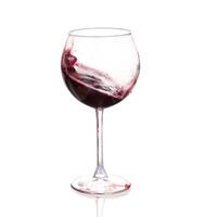 A wine glass with red liquid in it photo