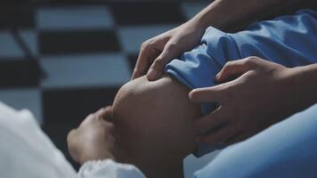 A person is getting their knee checked by a doctor video