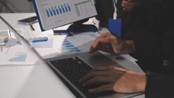 A person using a laptop computer with graphs on it video