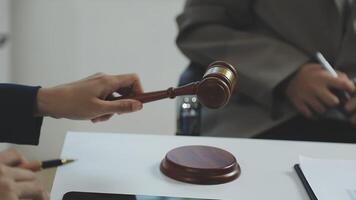 A judge is holding a gavel over a table video
