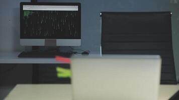 A laptop computer sitting on a desk in front of a monitor video