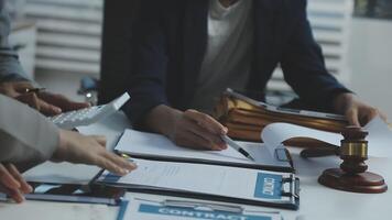 Business people at a table with papers and a gavel video