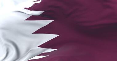 Flag of Qatar waving at wind in slow with blue sky, loop video