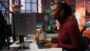 IT startup worker using language model application to get help with coding tasks. Woman interacting with AI LLM chatbot on PC in software development workplace, camera B photo