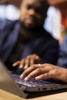 Couple working remotely in their apartment, planning business strategies and discussing project development while using a laptop to track progress and ensure success. photo