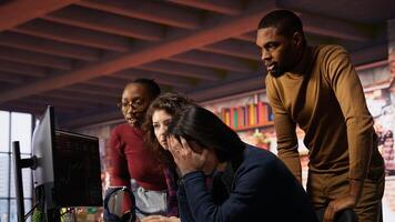 Startup team concerned by company stock dropping, signaling future funding challenges. Venture management distraught by financial decline leading to budget cuts and layoffs, camera B photo